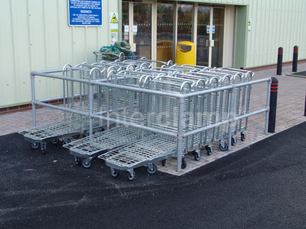 Close-up of a shopping trolley bay assembled with Interclamp Trolley Bay kits, showcasing the modular design and the included fittings and tubes for straightforward construction.